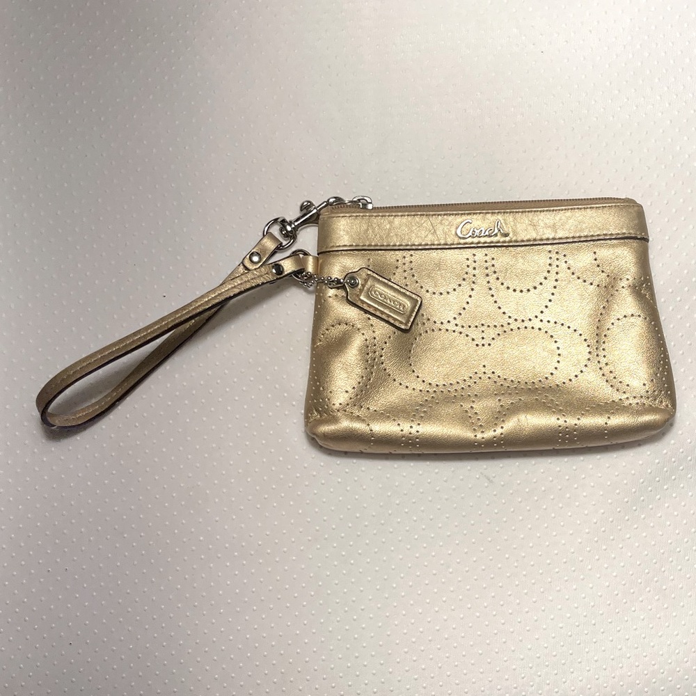 COACH Metallic Gold Leather Wristlet With Perforated C-Signature Design.